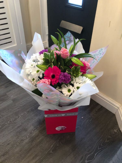 Ashleigh - A budding delight, complimented by greenery and presented in a gift box/bag. Beautiful flower bouquet hand delivered by the local florist.