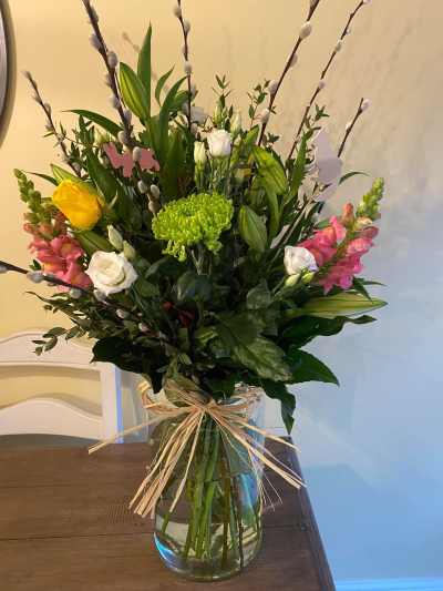 The Happy Vase - Happy Vase floral arrangement, made up of bright blooms and leaves.
